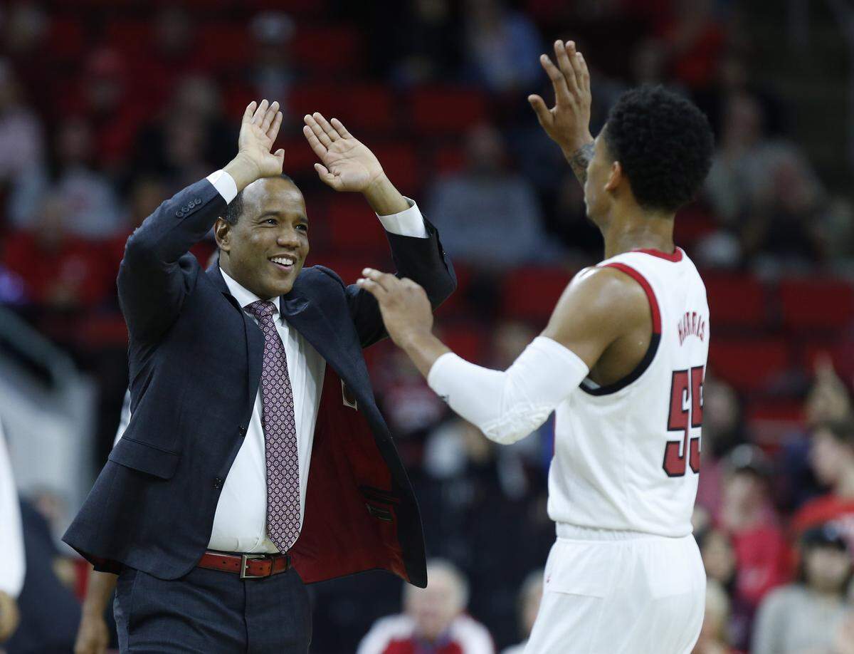 N.C. State head coach Kevin Keatts high-fives Blake Harris (55) as a timeout in called during the first half of N.C. State’s game against UNC-Asheville at PNC Arena in Raleigh, N.C., Tuesday, Nov. 13, 2018.