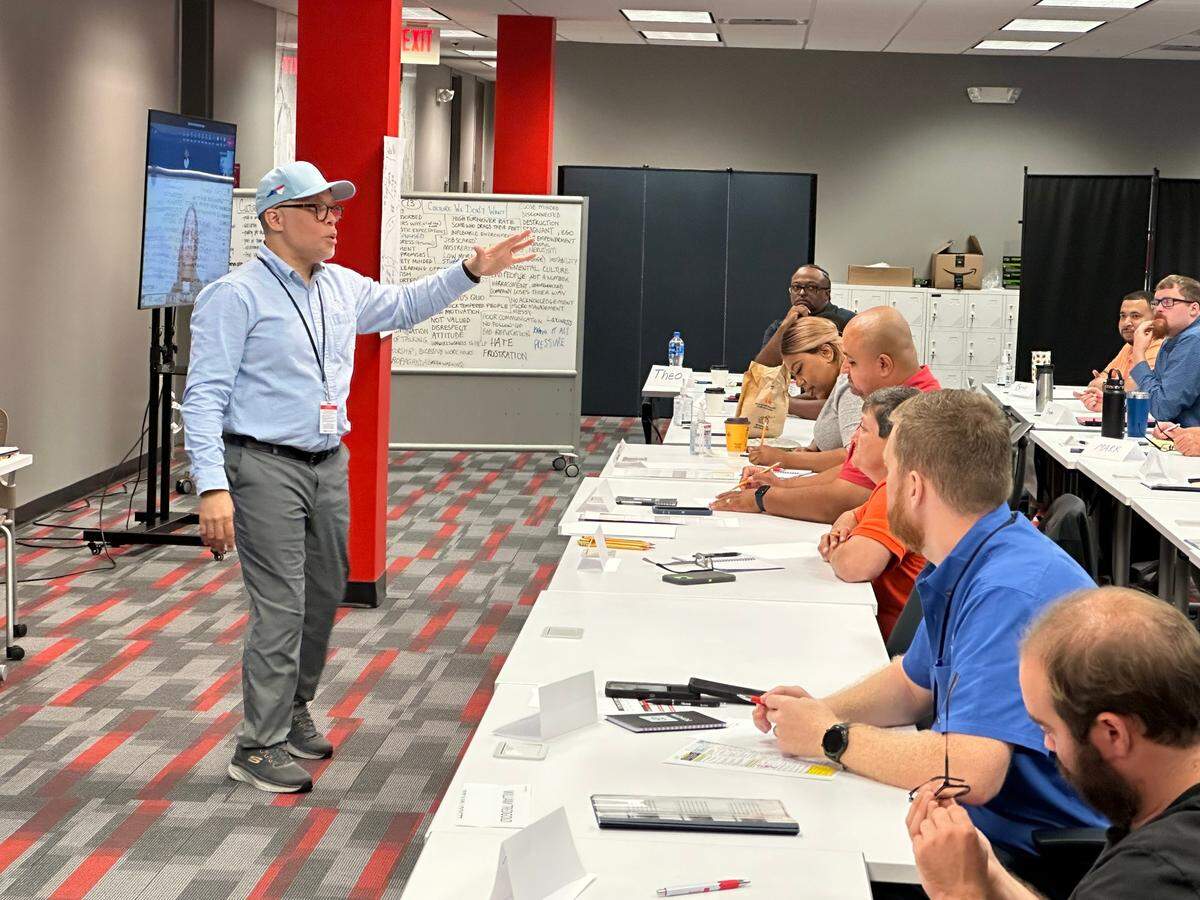 Derrick Taylor, senior manager for the Center of Excellence at Toyota Battery Manufacturing North Carolina, leads a class of new hires at the company’s hiring and training center in Greensboro, N.C., on Wednesday, Oct. 4.