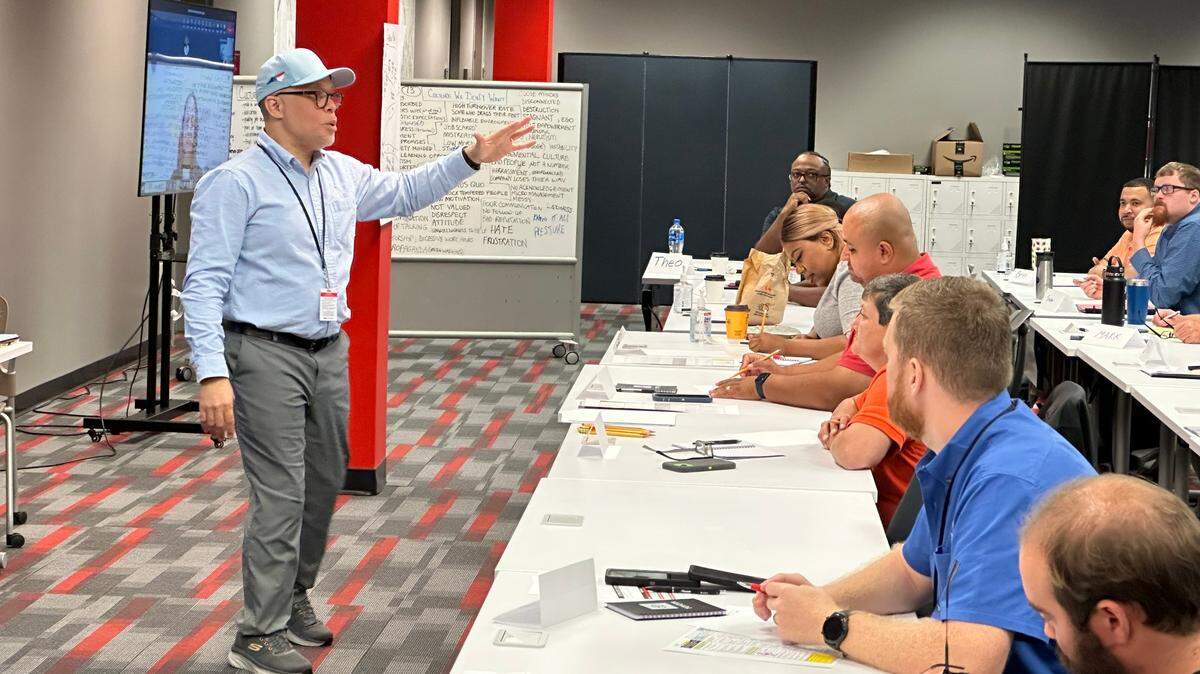 Derrick Taylor, senior manager at Toyota Battery Manufacturing North Carolina, leads a class of new hires at the company’s temporary training center in Greensboro, N.C. on Wednesday, Oct. 4, 2023. Toyota won’t begin producing batteries at its new factory in Randolph County until 2025, but the company has already begun hiring the people who will make them.