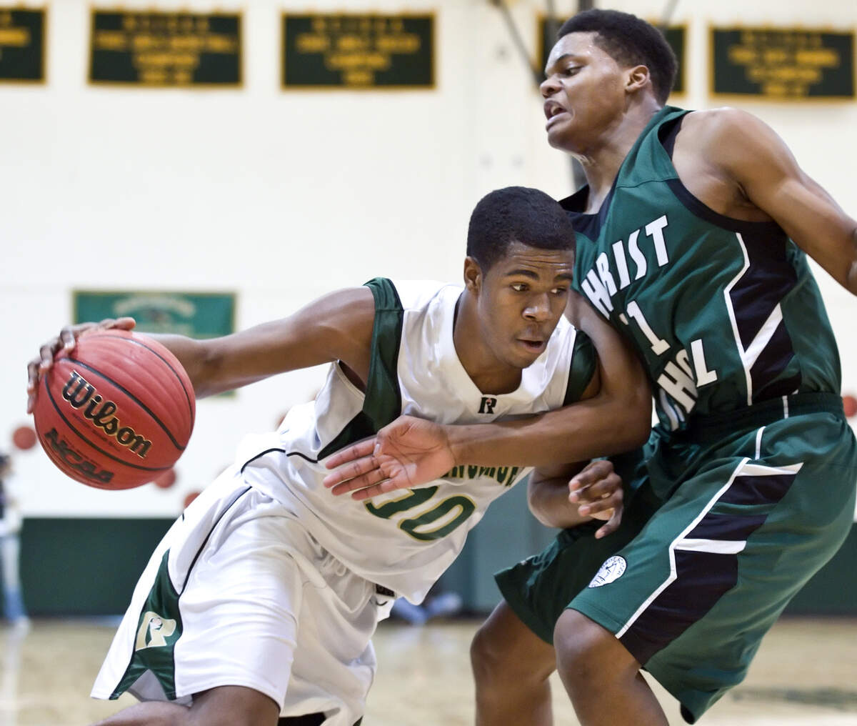 Ravenscroft junior Anton Gill (10), left, looks to drive past Christ School sophomore Josh Level (11), right. Gill led all scorers with 34 points. Christ School of Arden, NC, played at Ravenscroft School on Friday, February 10, 2012. Ravenscroft won the game 83-73. - GREG MINTEL
