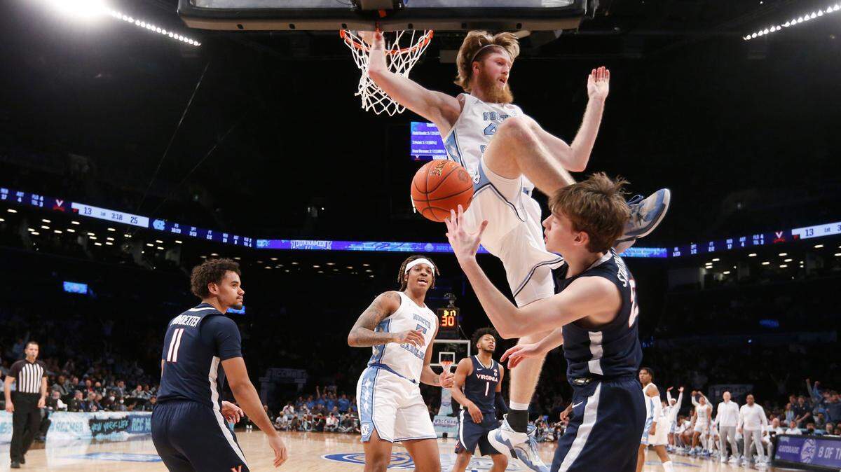 North Carolina’s Brady Manek (45) comes down over Virginia’s Kody Stattmann (23) after slamming in two during UNC’s 63-43 victory over Virginia in the quarterfinals of the ACC men’s basketball tournament at the Barclays Center in Brooklyn, N.Y., Thursday, March 10, 2022.