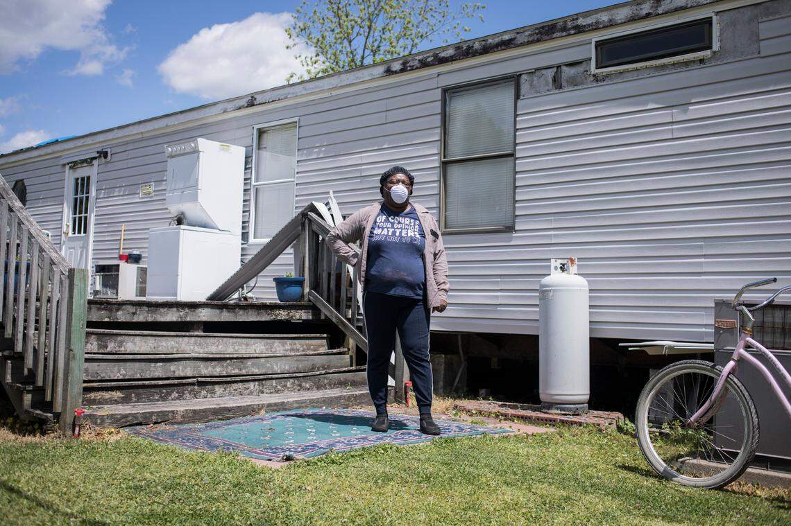 Arlisha Hill poses for a portrait behind her home in Maple Hill, N.C., which was damaged in Hurricane Florence, on Monday, April 27, 2020. Hill lived in a FEMA trailer in her yard for 15 months and moved back into her unfinished home on March 14. Although a few things still need work, she’s happy to be safe and back in the comfort of her home, despite the threat of COVID-19.