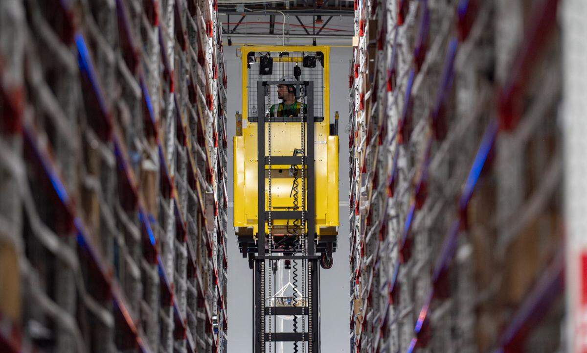 An Amazon worker uses a lift to collect larger items to ship at the SNC3 Same-Day Delivery Fulfillment Center in Durham on Wednesday July 10, 2024.