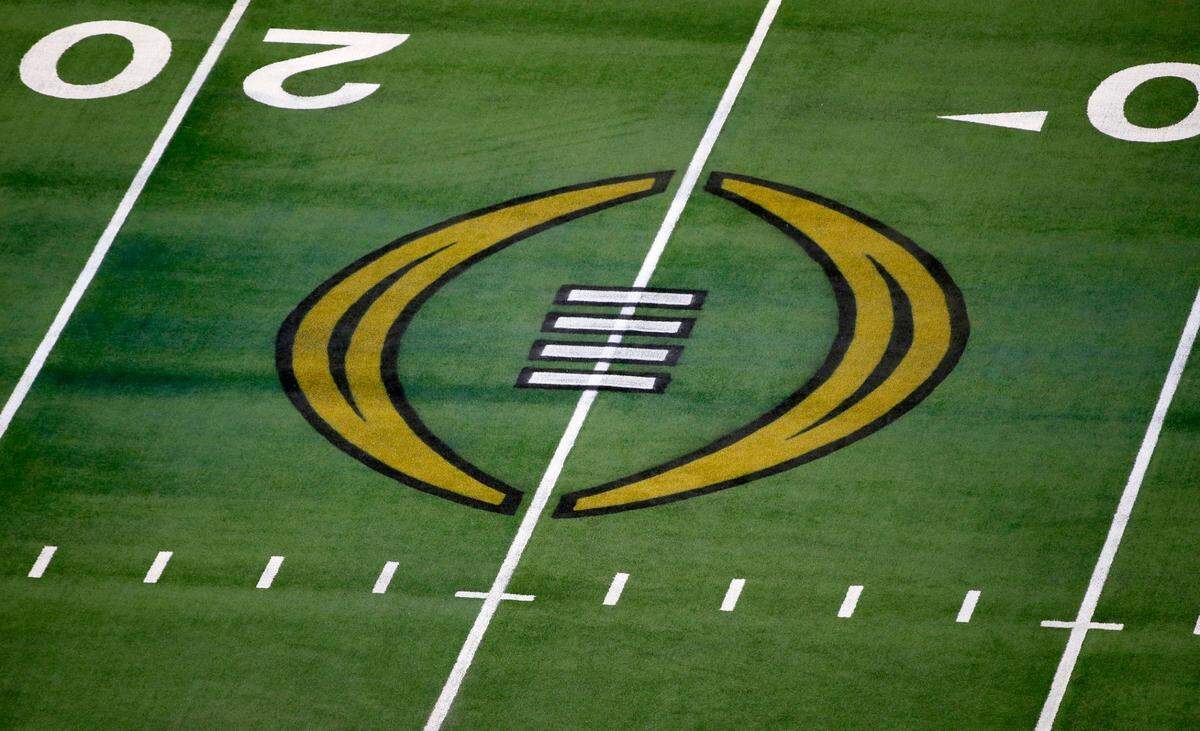FILE - The College Football Playoff logo is shown on the field at AT&T Stadium before the Rose Bowl NCAA college football game between Notre Dame and Alabama in Arlington, Texas, Jan. 1, 2021. The College Football Playoff announced Thursday, Dec. 1, 2022, it will expand to a 12-team event, starting in 2024, finally completing an 18-month process that was fraught with delays and disagreements. The announcement comes a day after the Rose Bowl agreed to amend its contract for the 2024 and ’25 seasons, the last hurdle CFP officials needed cleared to triple the size of what is now a four-team format. (AP Photo/Roger Steinman, File)