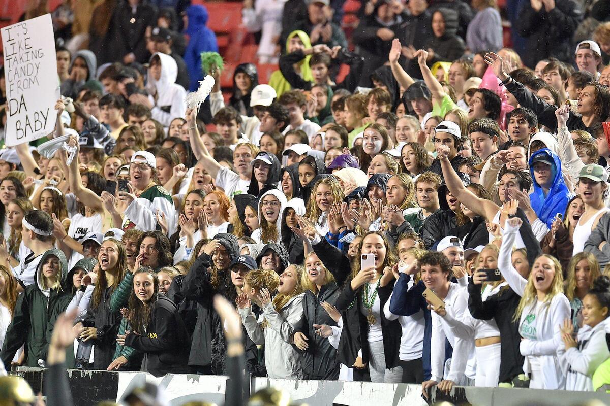 Cardinal Gibbons fans celebrate after an interception late in the second half. The Cardinal Gibbons Crusaders and the Julius Chambers Cougars met in the NCHSAA 4A Football Championship game in Raleigh, N.C. on December 11, 2021.