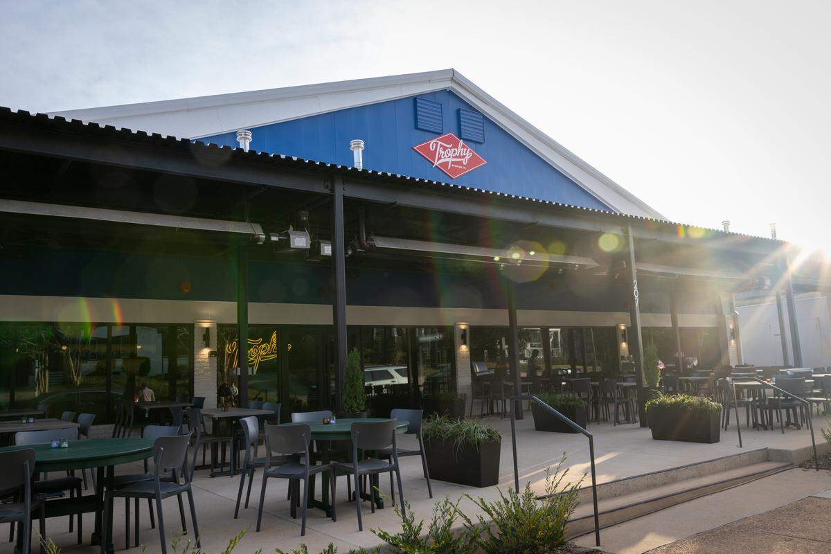 The iconic blue Electric Supply Co. warehouse on Bickett Road is now the newest taproom and restaurant location from Trophy Brewing.