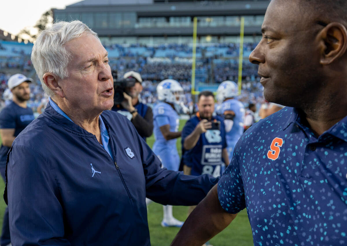Syracuse head coach Dino Babers congratulates North Carolina coach Mack Brown following the Tar Heels’ 40-7 victory on Saturday, October 7, 2023 at Kenan Stadium in Chapel Hill, N.C.