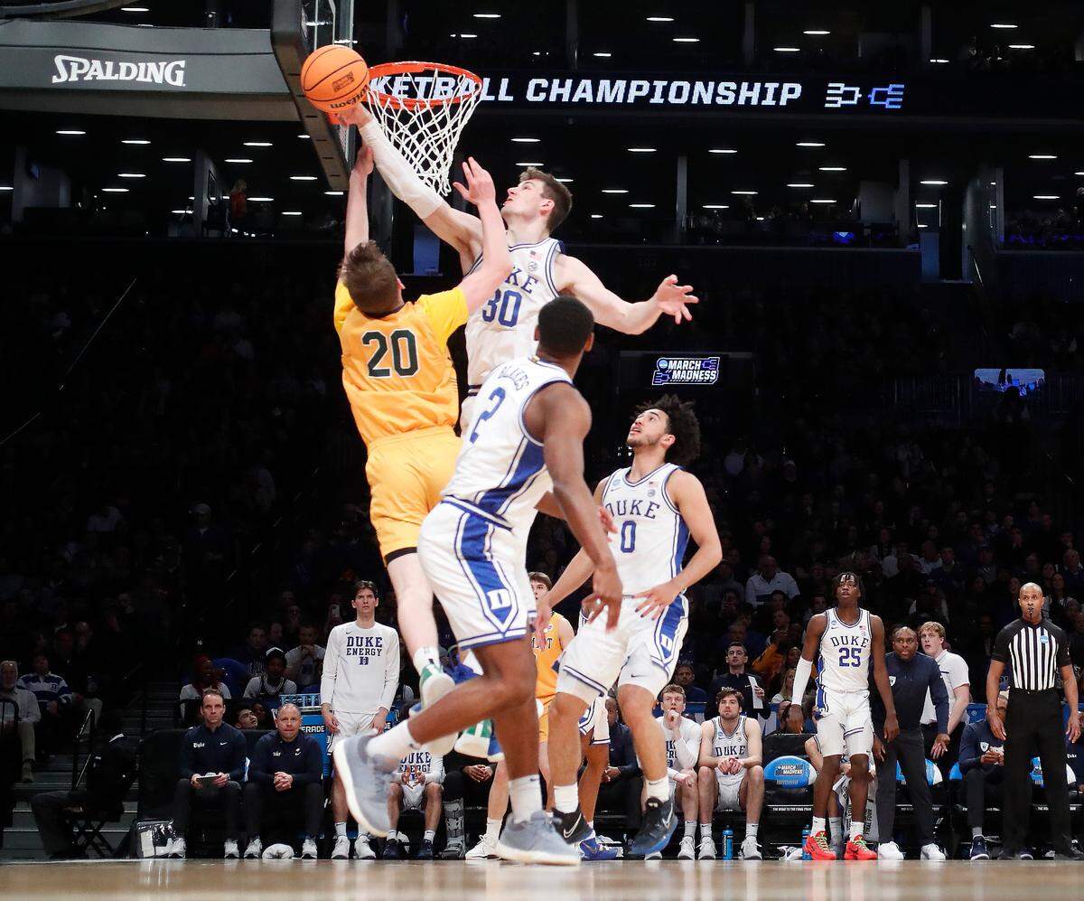 Duke’s Kyle Filipowski (30) blocks the shot by Vermont’s TJ Long (20) during Duke’s 64-47 victory over Vermont in the first round of the NCAA Tournament at the Barclays Center in Brooklyn, N.Y., Friday, March 22, 2024.