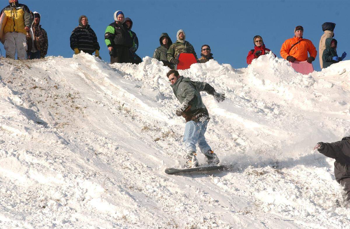 Greg Bailey of Kill Devil Hills tries out his snow board at the Wright Brothers Memorial after a winter storm dumped several inches of snow on the Outer Banks in January 2002.
