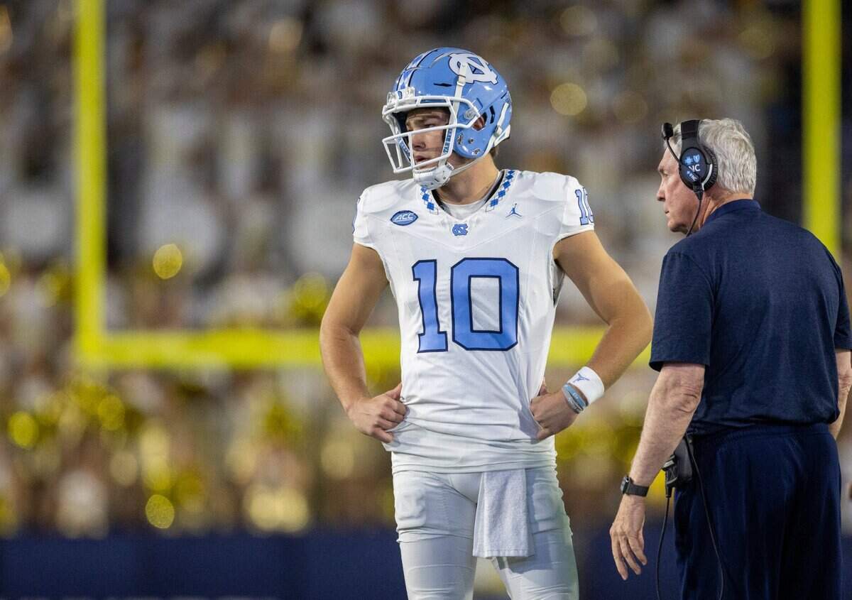 North Carolina quarterback Drake Maye (10) confers with coach Mack Brown during a time out in the first quarter on Saturday, October 28, 2023 at Bobby Dodd Stadium in Atlanta, Georgia.