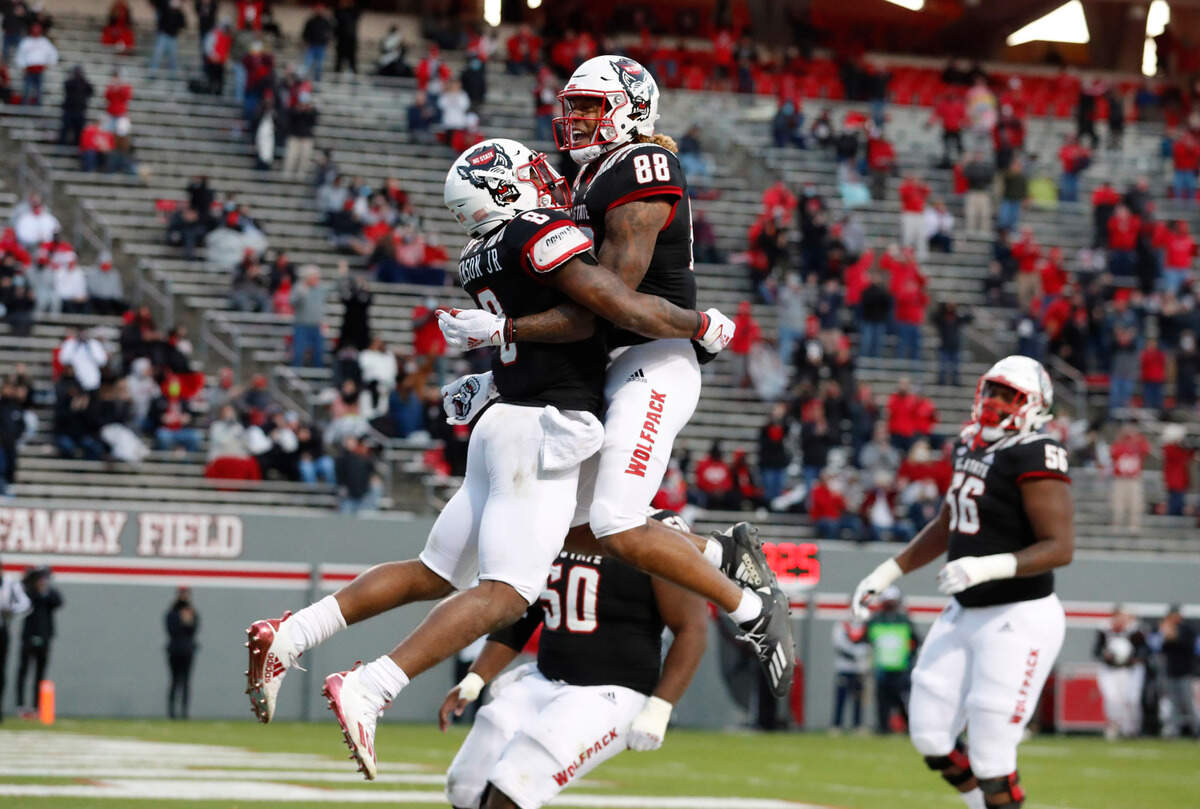 N.C. State running back Ricky Person Jr. (8) celebrates with Devin Carter (88) after scoring on a 20-yard touchdown run during the first half of N.C. State’s game against Georgia Tech at Carter-Finley Stadium in Raleigh, N.C., Saturday, Dec. 5, 2020.