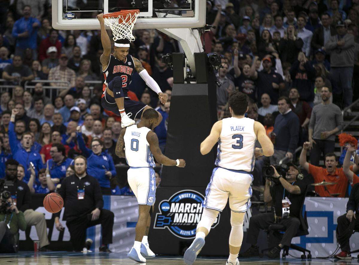 Auburn’s Bryce Brown (2) hangs on the rim in celebration after a dunk to ice the Tigers’ victory over North Carolina in the NCAA Sweet 16 matchup on Friday, March 29, 2019 at the Sprint Center in Kansas City, Missouri. Auburn rolled to a 97-80 victory.