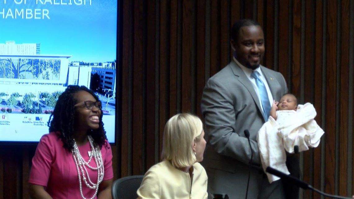 Raleigh Council member Corey Branch presents his daughter, Carleigh Ivy-Rose Branch, along with his wife Chanda at an Oct. 16, 2018, city council meeting.
