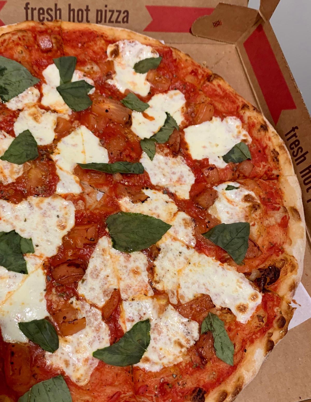 The margherita Veritas at Pizzeria Veritas in Cary is made up of fresh mozzarella, tomatoes, garlic and a generous scattering of torn basil leaves.