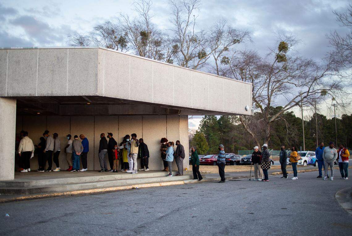 Fans waiting to see the Kinston High School Vikings and the Cummings High School Cavaliers face off in the state playoffs line up outside the school gym in Kinston, N.C. on Tuesday, March 1, 2022.