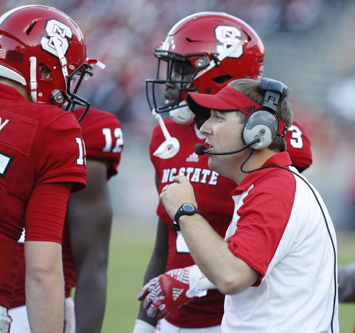 N.C. State offensive coordinator Eliah Drinkwitz talks with quarterback Ryan Finley (15), left, during the second half of N.C. State’s 33-16 victory over Wake Forest at Carter-Finley Stadium in Raleigh, N.C., Saturday, October 1, 2016.