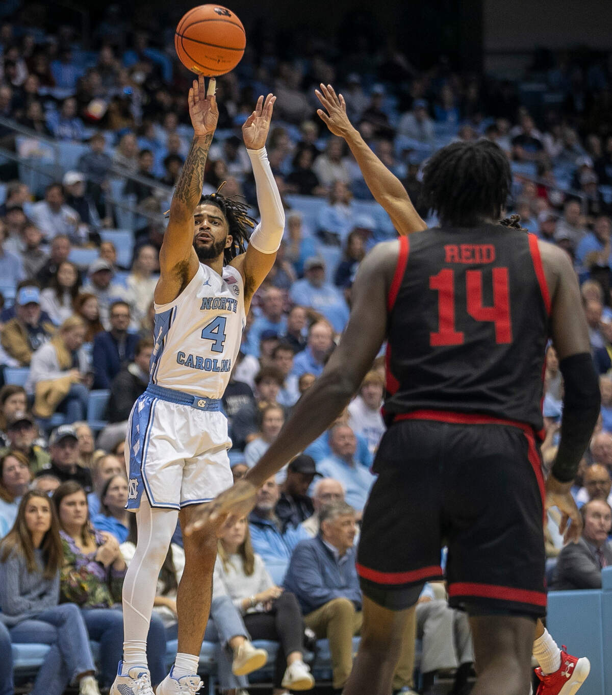 North Carolina’s R.J. Davis (4) launches a three-point shot over Gardner-Webb’s Kareem Reid (14) during the first half on Tuesday, November 15, 2022 at the Smith Center in Chapel Hill, N.C.