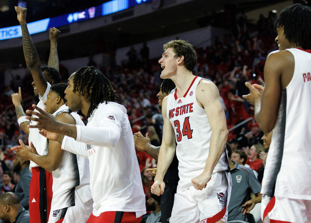 The N.C. State bench reacts after a made basket during the second half of the Wolfpack’s 74-68 win over Miami on Tuesday, Jan. 30, 2024, at PNC Arena in Raleigh, N.C.