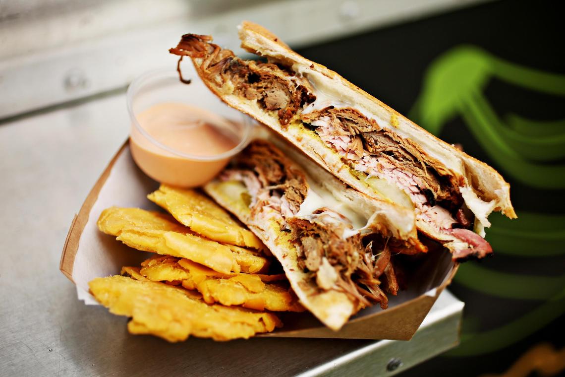 Pernil is also featured in Spanglish’s take on a Cubano sandwich, where it plays a costarring role along with Antonio Rodriguez’s house-baked Puerto Rican bread. A little softer than the Cuban version, the bread gives the sandwich a subtle Puerto Rican twist. It is served here with Tostones de Pana, fried breadfruit.