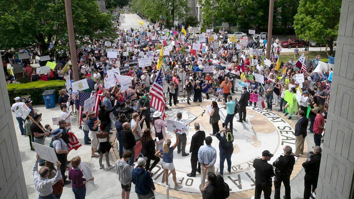 Protesters from ReOpen NC gather at the entrance to the Legislature moments before the House and Senate were set to convene on Tuesday, April 28, 2020 in Raleigh, N.C. ReOpen NC is calling on North Carolina Governor Roy Cooper and elected officials to re-open the state’s economy after being closed due to the spread of the COVID-19 virus.