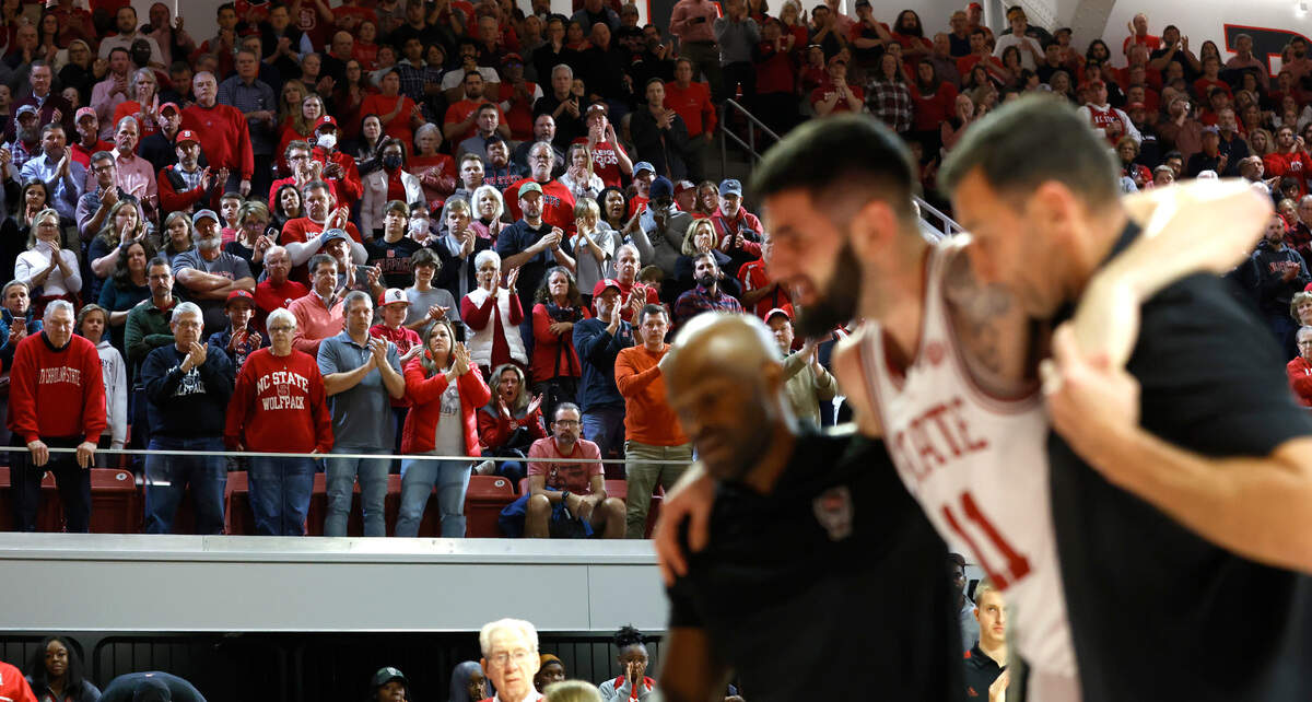 N.C. State’s Dusan Mahorcic is given a standing ovation from fans as he is helped off the court after he was injured during the second half of N.C. State’s 94-72 victory over Coppin State at Reynolds Coliseum in Raleigh, N.C., Tuesday, Dec. 6, 2022.