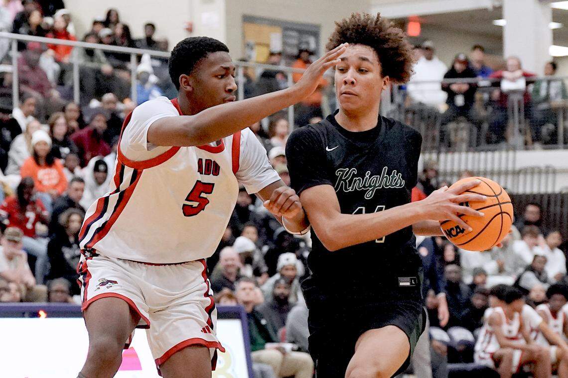 Greenfield's Cameron Moore (14) drives to the basket against Coronado's DeVaughn Dorrough (5) during the second half. The Greenfield Knights and the Coronado Cougars (Nevada) met in the finals of the Day'Ron Sharpe bracket of the  John Wall Holiday Tournament in Raleigh, N.C. on December 30, 2025.