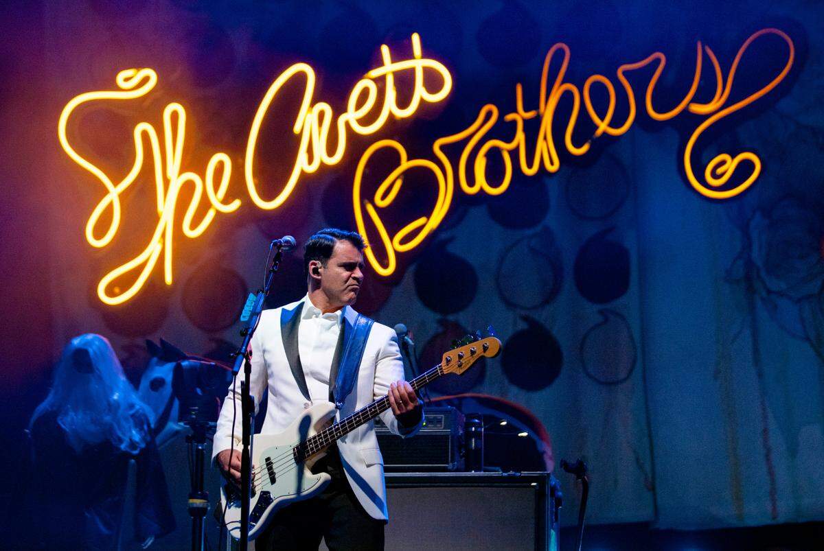 Bassist Rob Crawford, decked out in a white tux jacket, performs with The Avett Brothers at Raleigh’s PNC Arena for their annual New Year’s Eve show, Dec. 31, 2023.