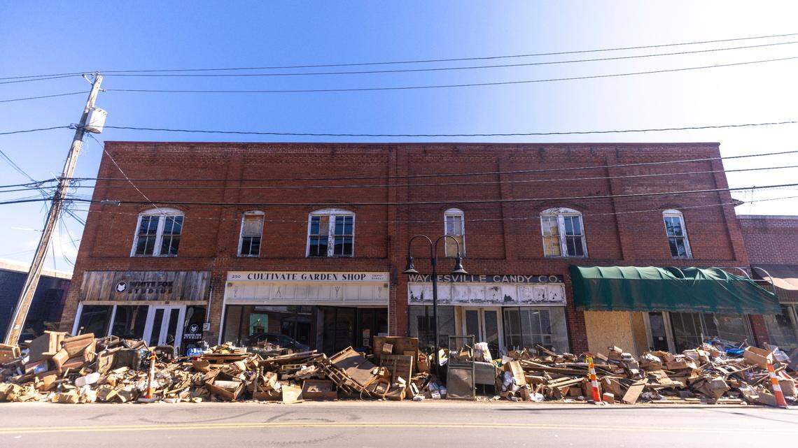 Debris removed from flood damaged businesses line a street in downtown Waynesville on Sunday, Oct. 6, 2024 after Tropical Storm Helene flooded Richland Creek. North Carolina officials have confirmed 76 deaths from Tropical Storm Helene.