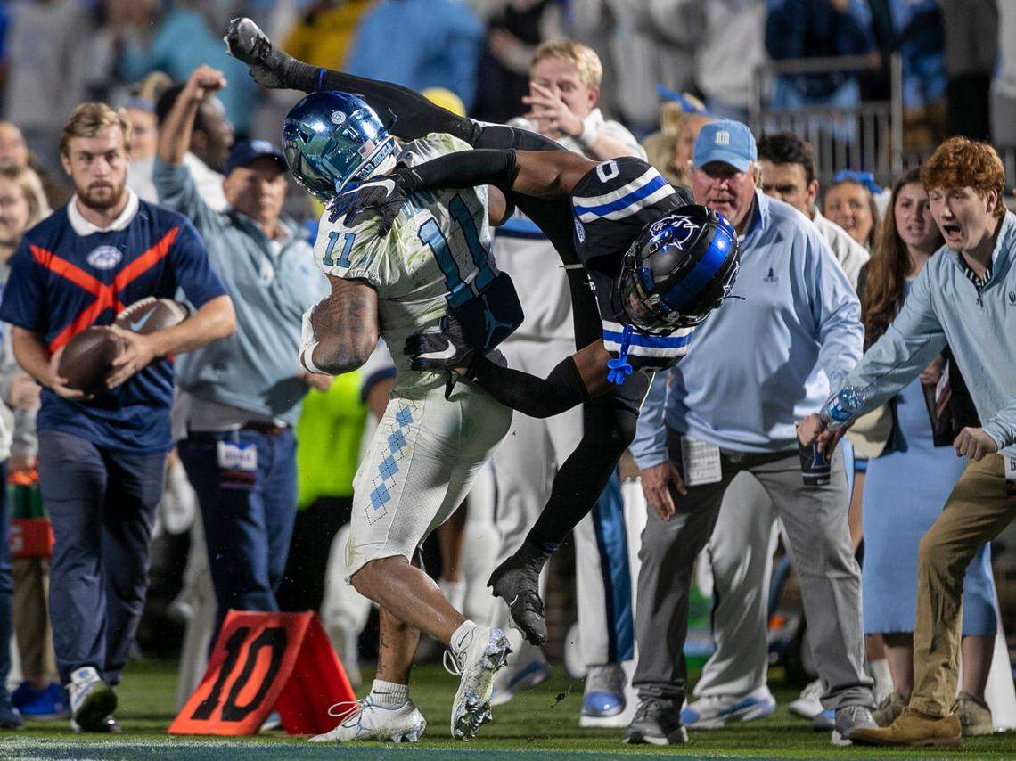 Duke’s Chandler Rivers (0) pushes North Carolina wide receiver Josh Downs (11) out of bounds after an 11-yard pass receptions from quarterback Drake Maye to set up the Tar Heels’ winning touchdown in the final minute of play on Saturday, October 15, 2022 at Wallace-Wade Stadium in Durham, N.C.