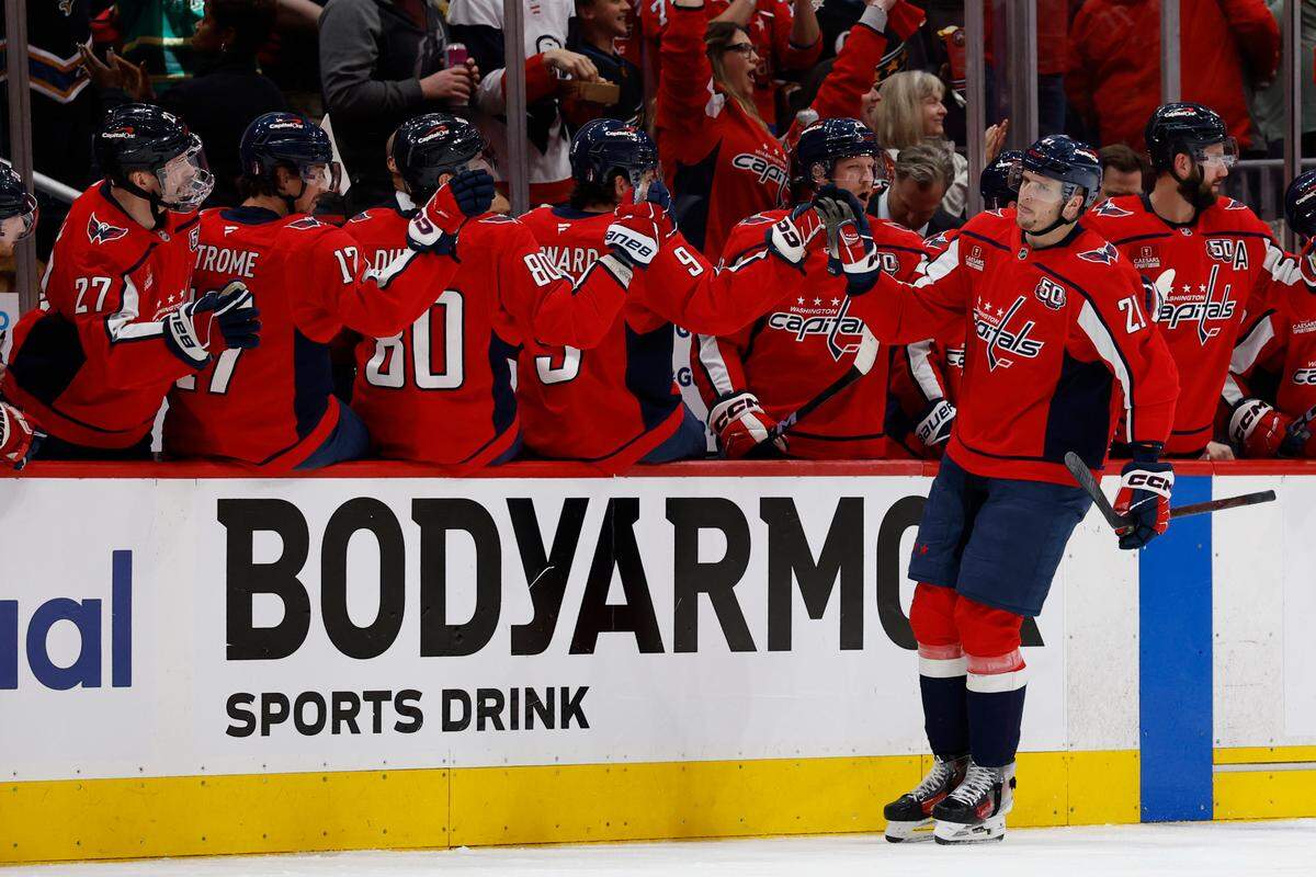 Washington Capitals center Aliaksei Protas (21) celebrates with teammates after scoring a goal against the Carolina Hurricanes in the second period in game one of the second round of the 2025 Stanley Cup Playoffs at Capital One Arena.