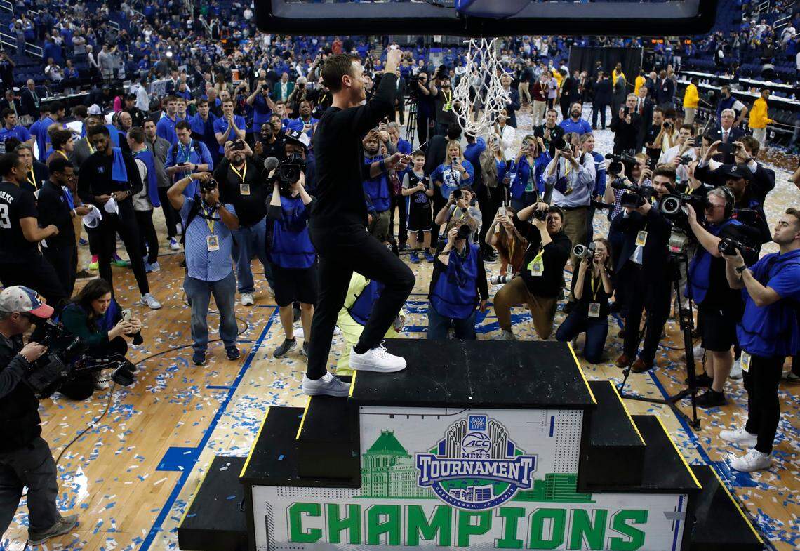 Duke head coach Jon Scheyer celebrates as he climbs the stairs to cut down the net after Duke’s 59-49 victory over Virginia to win the ACC Men’s Basketball Tournament in Greensboro, N.C., Saturday, March 11, 2023.
