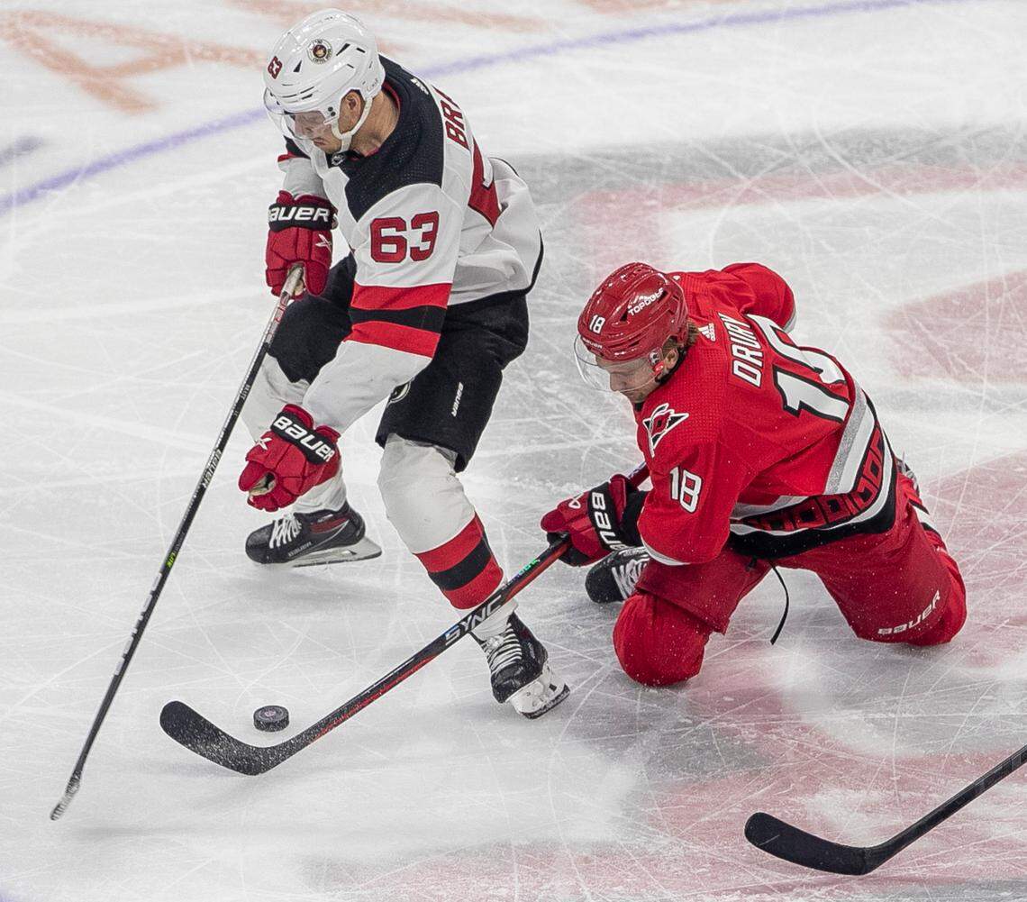 The Carolina Hurricanes Jack Drury (18) goes after the puck under the New Jersey Devils Jesper Bratt (63) in the third period during Game 1 of their second round Stanley Cup playoff series against the New Jersey Devils on Wednesday, May 3, 2023 at PNC Arena in Raleigh, N.C.