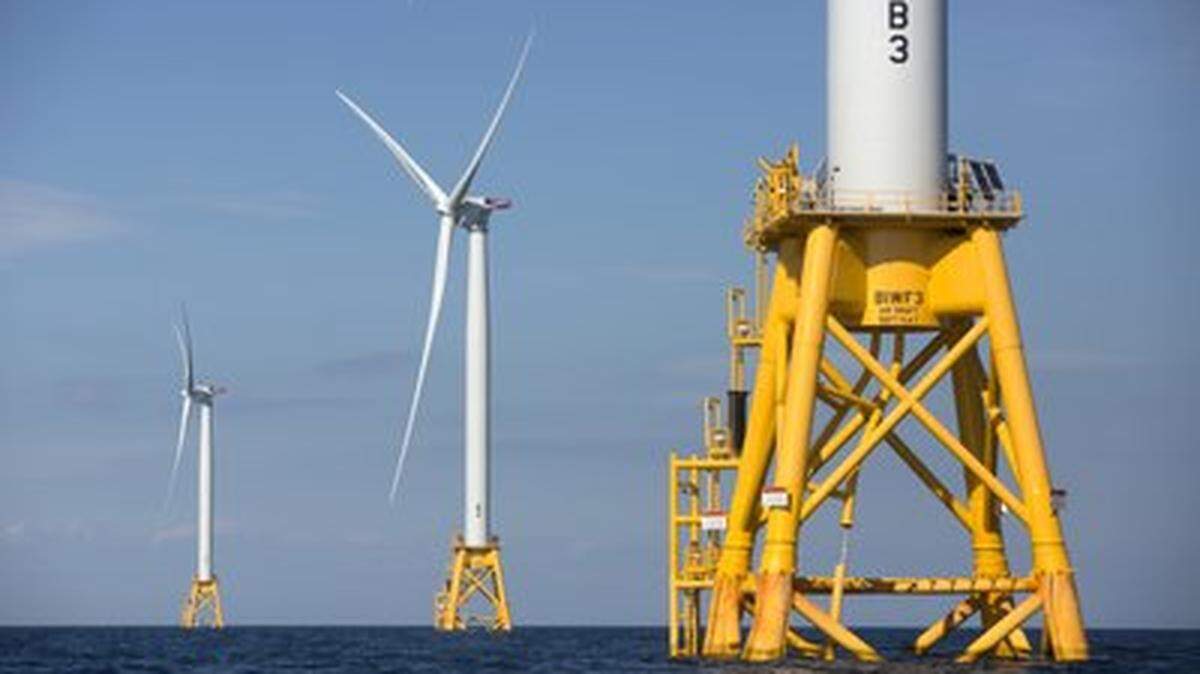 In this Monday, Aug. 15, 2016, file photo, three of Deepwater Wind’s turbines stand in the water off Block Island, R.I. A huge wind farm off the Massachusetts coast is edging closer to federal approval, setting up what the Biden administration hopes will be a model for a sharp increase in offshore wind energy development along the East Coast.(AP Photo/Michael Dwyer, File)