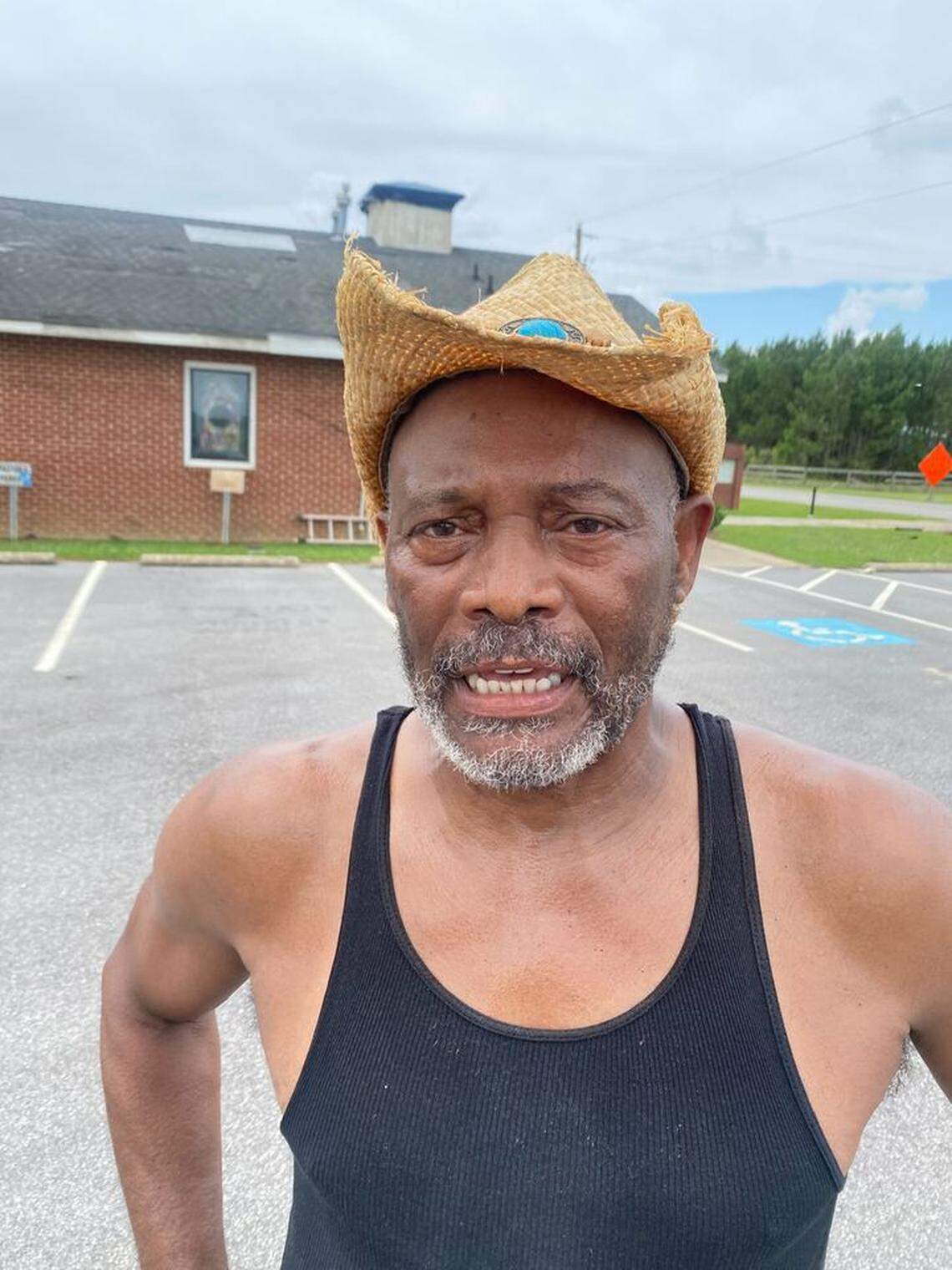 The Rev. Elbert Heath examines the damage at Morning Star Baptist Church in Battleboro, North Carolina, on Thursday, July 20. A tornado on Wednesday blew the steeple off the church.