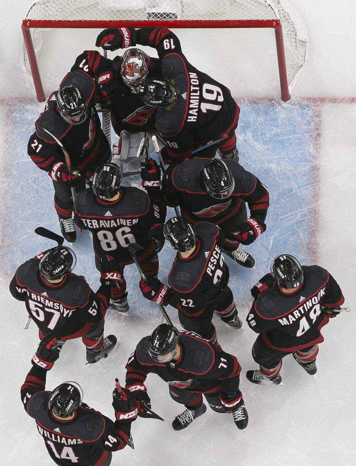 Carolina Hurricanes goalie Petr Mrazek is surrounded by his teammate as they celebrate their 5-0 victory over the Washington Capitals on Monday, April 15, 2019 at the PNC Arena on Raleigh, N.C.