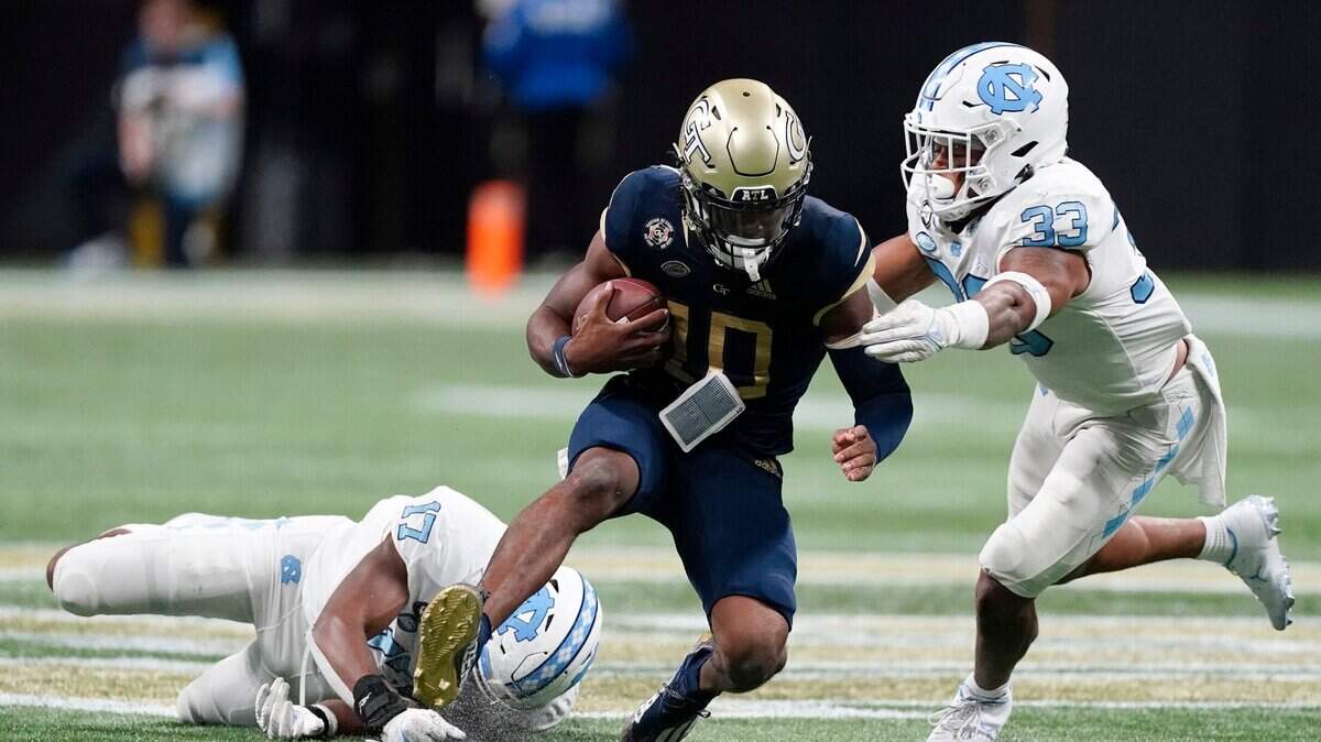 Georgia Tech quarterback Jeff Sims (10) is stopped by North Carolina linebackers Cedric Gray (33) and Chris Collins (17) after a short run in the second half of an NCAA college football game Saturday, Sept. 25, 2021, in Atlanta.