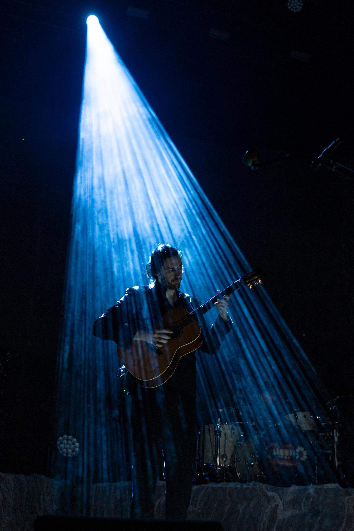 Hozier emerges from a spotlight at Coastal Credit Union Music Park at Walnut Creek in Raleigh, N.C., Saturday night, April 20, 2024.