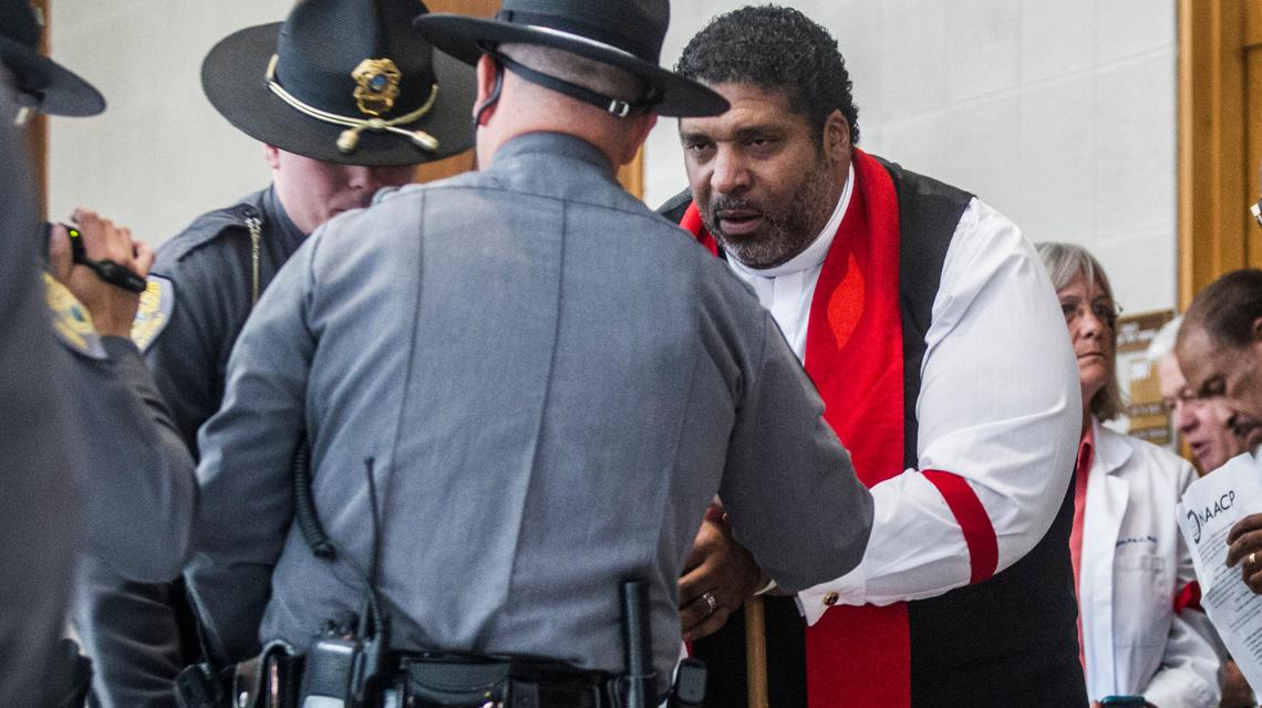 Rev. William Barber II, president of the NC NAACP, is arrested in front of Sen. Phil Berger’s office during a sit-in Tuesday, May 30, 2017. Thirty-two people were arrested for second-degree trespassing according to General Assembly police chief Martin Brock.