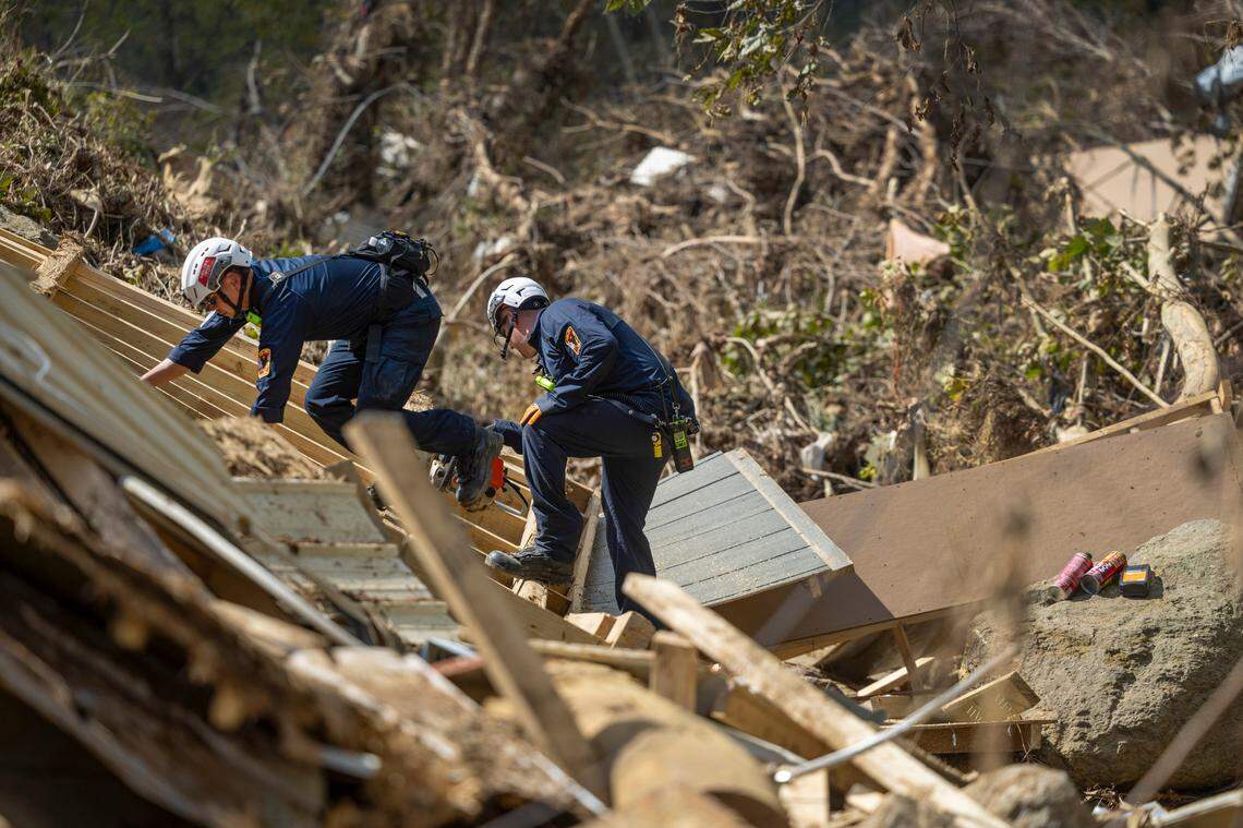A FEMA search and rescue team from Maryland search for human remains in debris from a structure in Swannanoa on Sunday, Oct. 6, 2024 after Tropical Storm Helene flooded the Swannanoa River. North Carolina officials have confirmed 76 deaths from Tropical Storm Helene.