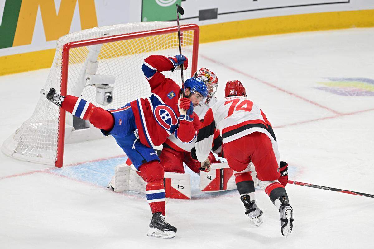 Nick Suzuki #14 of the Montreal Canadiens and Jaccob Slavin #74 of the Carolina Hurricanes collide during the first period in Game Four of the Eastern Conference Final of the 2026 Stanley Cup Playoffs at Bell Centre on May 27, 2026 in Montreal, Quebec, Canada. 