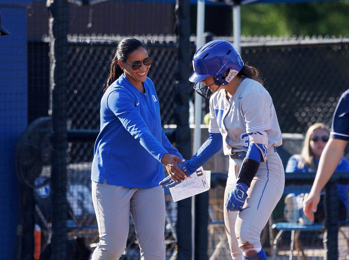 Duke’s Kelly Torres gets a high five from head coach Marissa Young after connecting for a triple during the sixth inning of the Blue Devils’ 6-0 win on Wednesday, April 24, 2024, in Durham, N.C.