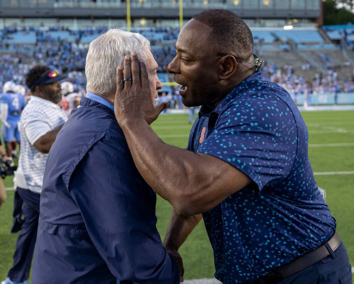 Syracuse head coach Dino Babers congratulates North Carolina coach Mack Brown following the Tar Heels’ 40-7 victory on Saturday, October 7, 2023 at Kenan Stadium in Chapel Hill, N.C.