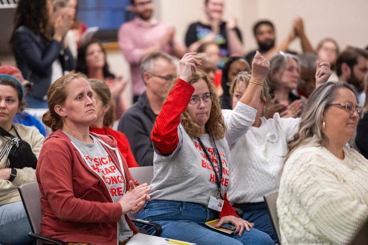 Durham Public Schools Board of Education meeting audience members applaud a public speaker Friday afternoon, February 2, 2024, at the Staff Development Center in Durham. DPS struggled to resolve salary issues that plunged the district into chaos. The issues stem from an accounting error that resulted in administration withdrawing raises promised to 1,300 school staff, prompting protests and strikes since mid-January.