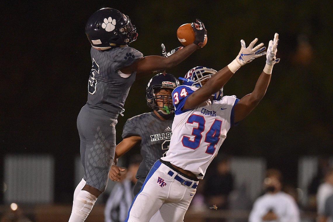 Millbrook’s Jaylen Bowen (5) intercepts the pass intended for Wake Forest’s Rico Alston (34) in the fourth quarter. The Millbrook Wildcats and the Wake Forest Cougars met in a football game in Raleigh, N.C. on October 29, 2021.