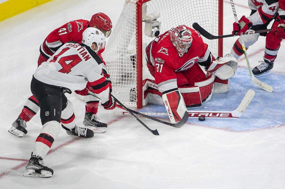 Carolina Hurricanes goalie Frederik Andersen (31) stops a scoring attempt by the New Jersey Devils Nathan Bastian (14) in overtime during Game 5 of their second round Stanley Cup playoff series on Thursday, May 11, 2023 at PNC Arena in Raleigh, N.C. Andersen made 27 saves in the Hurricanes’ 3-2 overtime victory.