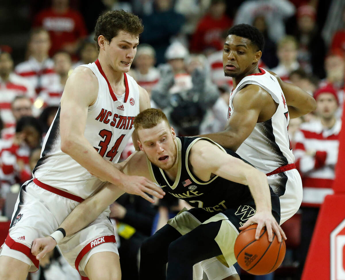 N.C. State’s Ben Middlebrooks and Casey Morsell pressure Wake Forest’s Cameron Hildreth during the second half of the Wolfpack’s 83-76 win at PNC Arena on Tuesday, Jan. 16, 2024, in Raleigh, N.C.