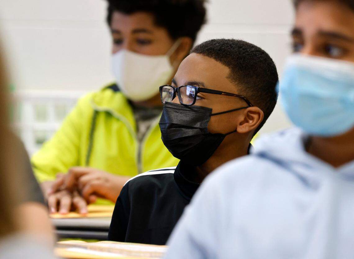 Michael Nero, center, listens during LaSonja Cunninghams 7th grade ELA class on the first day of school at Wakefield Middle School in Raleigh, N.C., Monday, August 23, 2021.