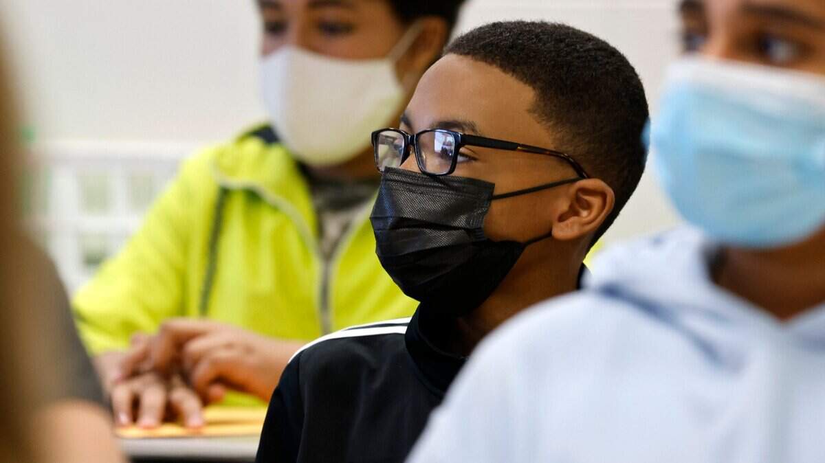Michael Nero, center, listens during LaSonja Cunninghams 7th grade ELA class on Aug. 23, 2021, the first day of school at Wakefield Middle School in Raleigh.