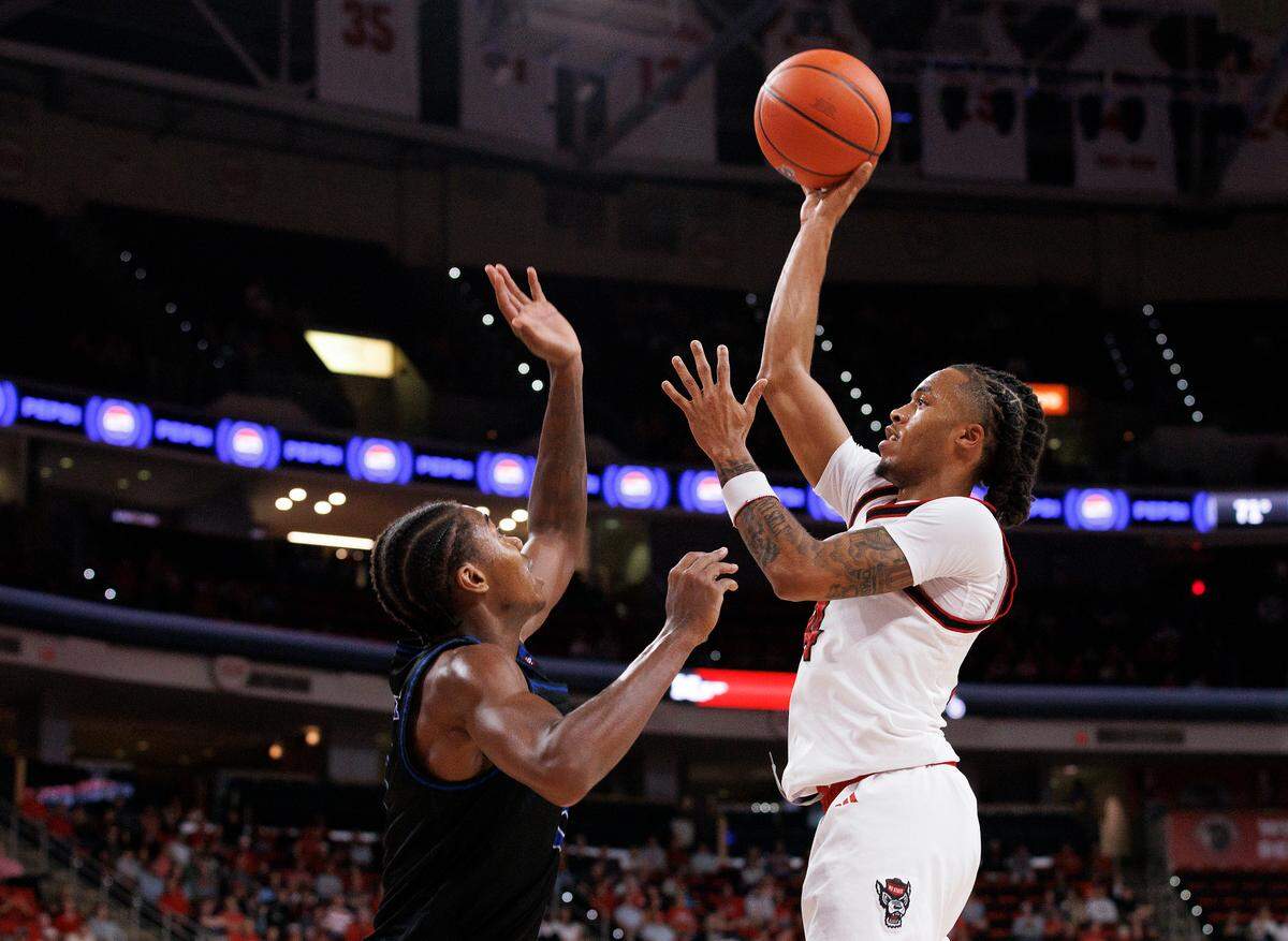 N.C. State’s Breon Pass shoots over Presbyterian’s Kobe Stewart during the second half of the Wolfpack’s 81-72 win on Friday, Nov. 8, 2024, at Lenovo Center in Raleigh, N.C.