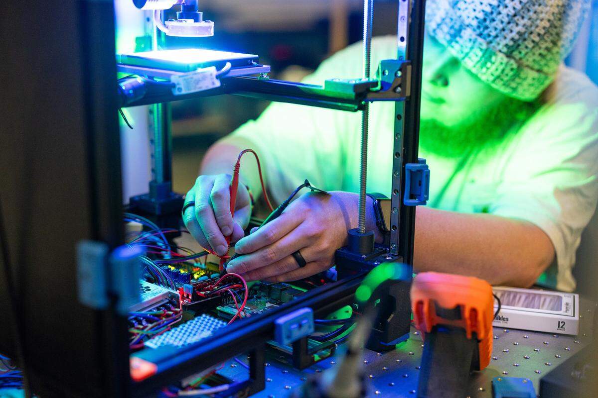 Electrical testing of components that power the robotics in the AI microscope, performed by App State student Ethan Hyman. The robotics and AI could help experts identify fecal parasite eggs faster, saving NC farmers time and money.